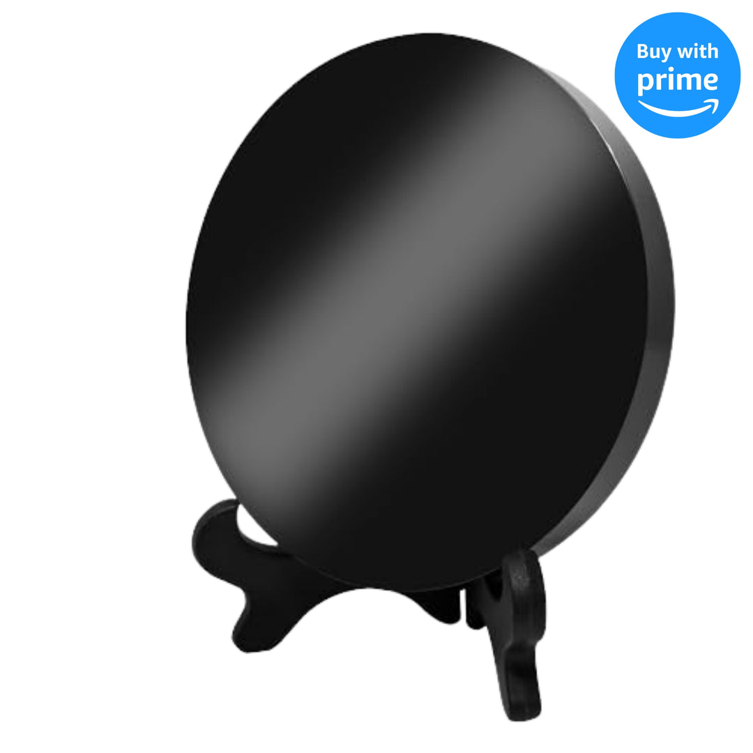 2.36 inch Black Obsidian Mirror resting on a black stand, ideal for witchcraft rituals and divination.
