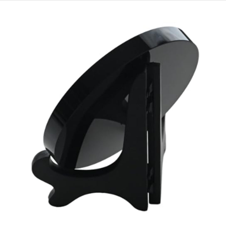 Side view of a high-quality obsidian scrying mirror displayed on a black stand, highlighting its smooth finish